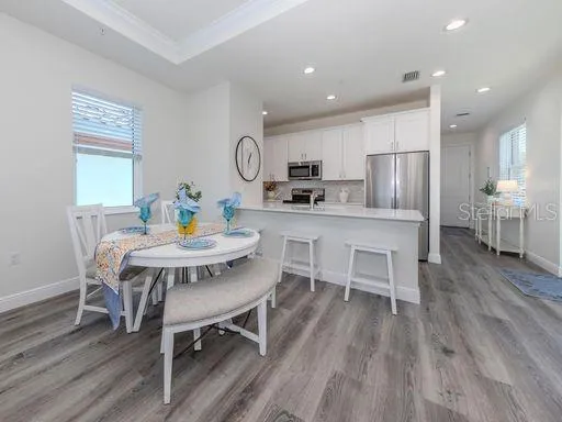 a view of a dining room with furniture wooden floor and a rug