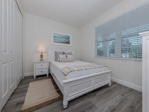 a bedroom with a bed and a painting on the wall