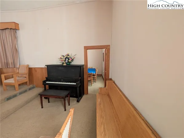 a living room with furniture and a piano