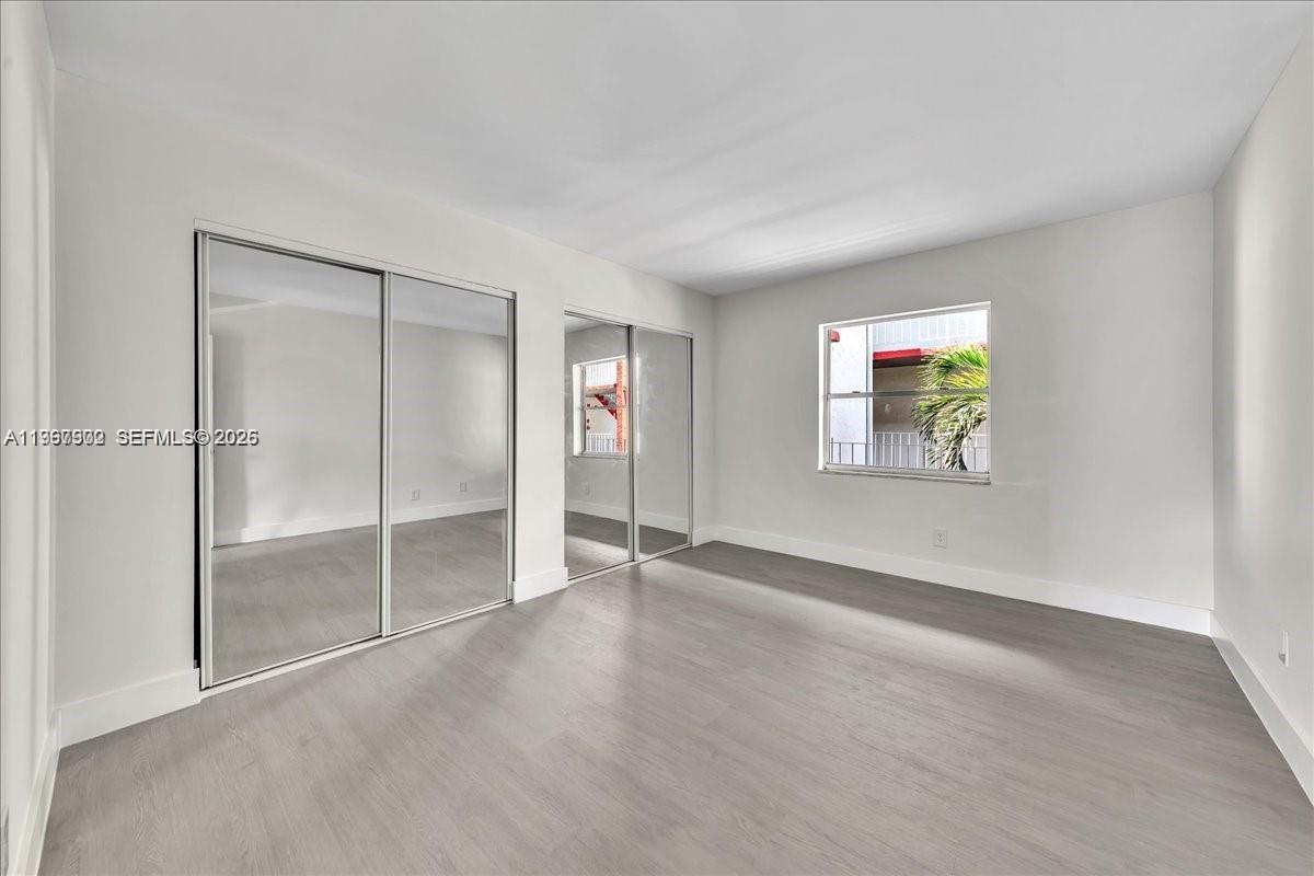 1750 West 46th Street, Unit 433 Hialeah, FL 33012 - Photo 11 of 27 an empty room with windows and closet