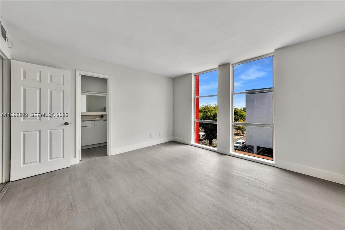 1750 West 46th Street, Unit 433 Hialeah, FL 33012 - Photo 17 of 27 an empty room with a fireplace and window