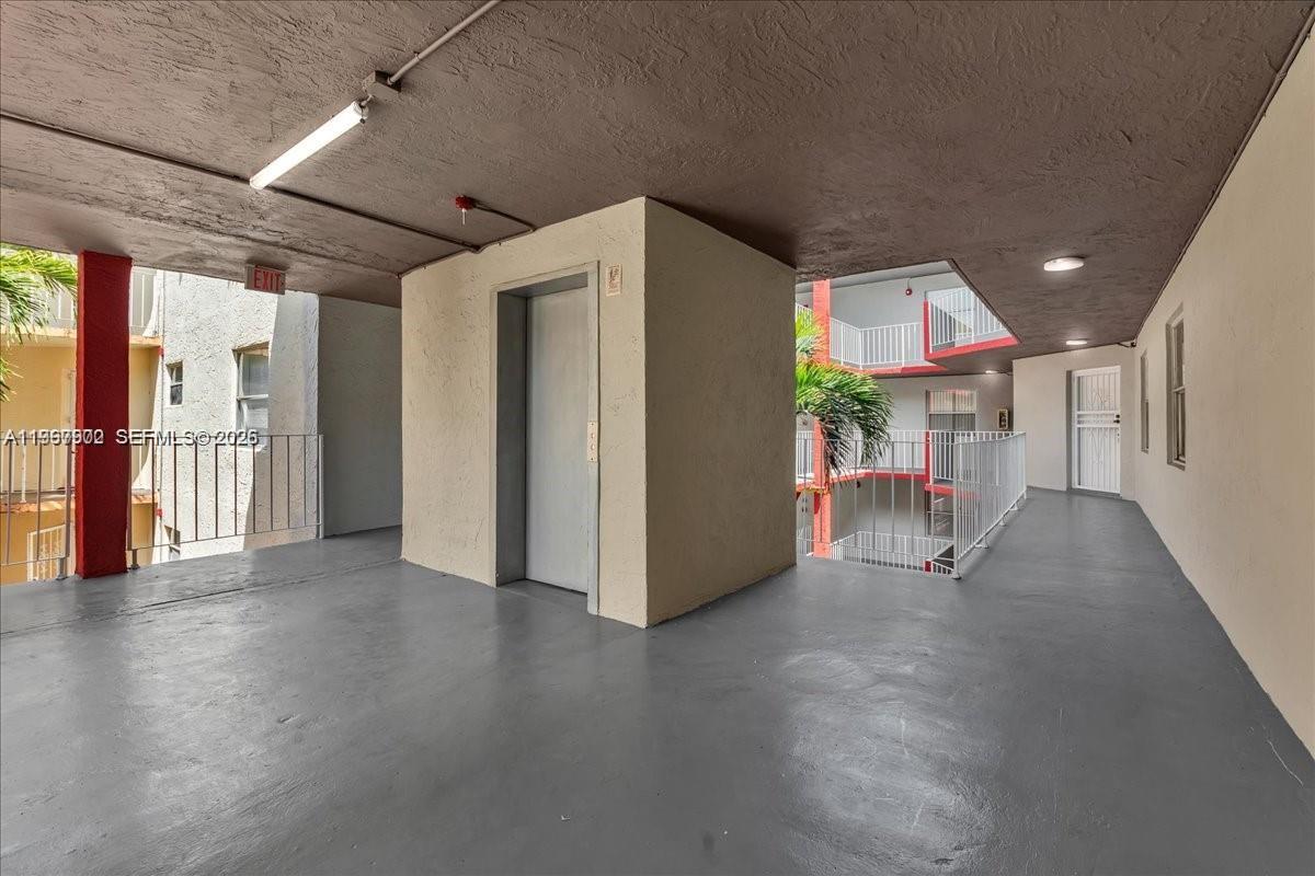 1750 West 46th Street, Unit 433 Hialeah, FL 33012 - Photo 26 of 27 a view of a hallway with wooden floor