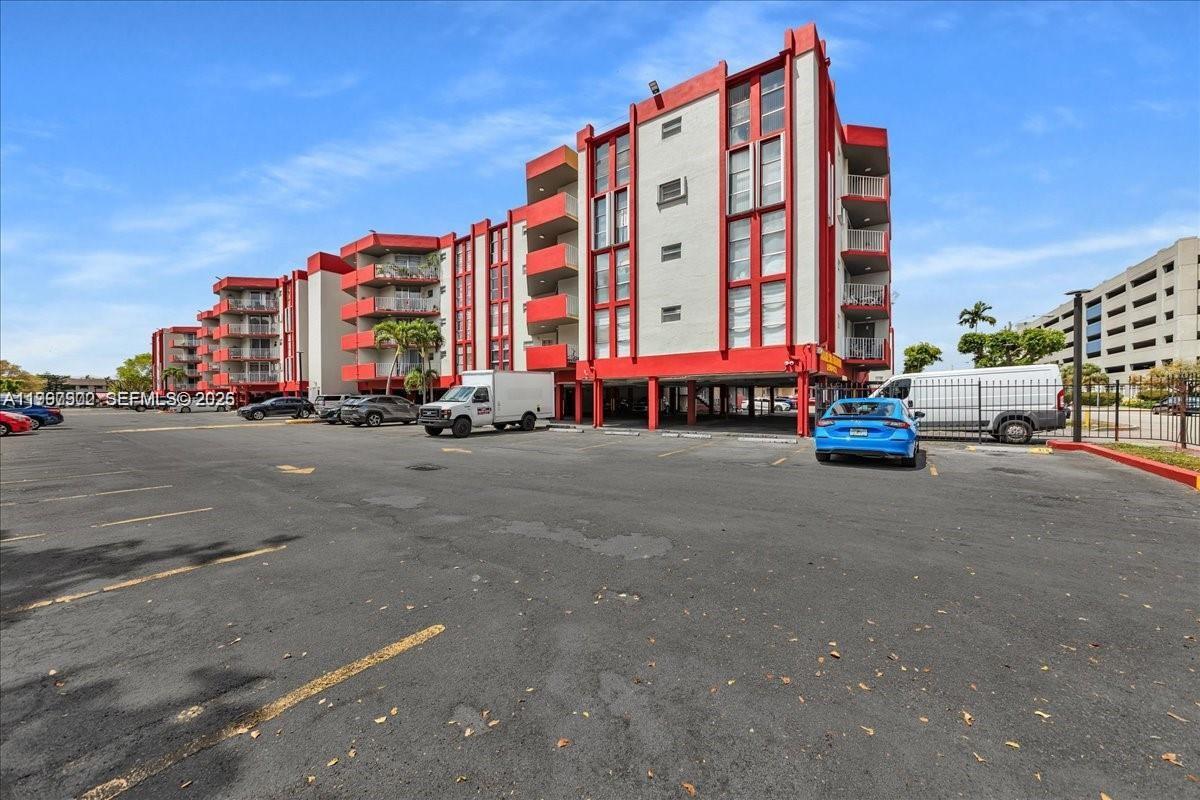 1750 West 46th Street, Unit 433 Hialeah, FL 33012 - Photo 27 of 27 a building with car parked in front of it