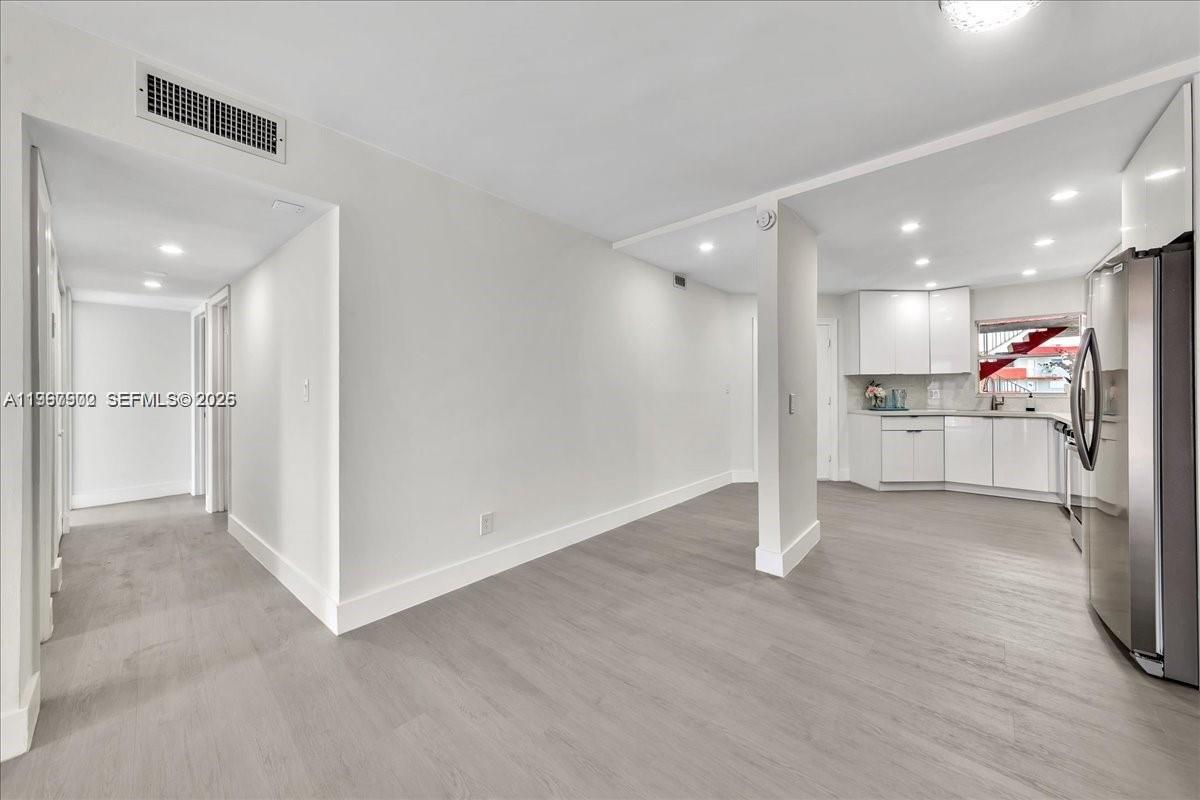 1750 West 46th Street, Unit 433 Hialeah, FL 33012 - Photo 6 of 27 a view of a kitchen with a sink and wooden floor
