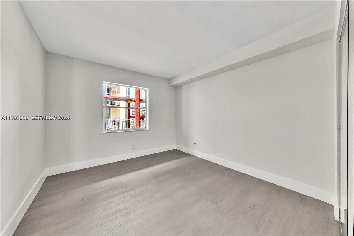 1750 West 46th Street, Unit 433 Hialeah, FL 33012 - Photo 8 of 27 an empty room with windows
