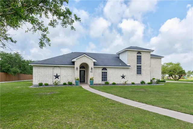 a front view of house with yard and green space