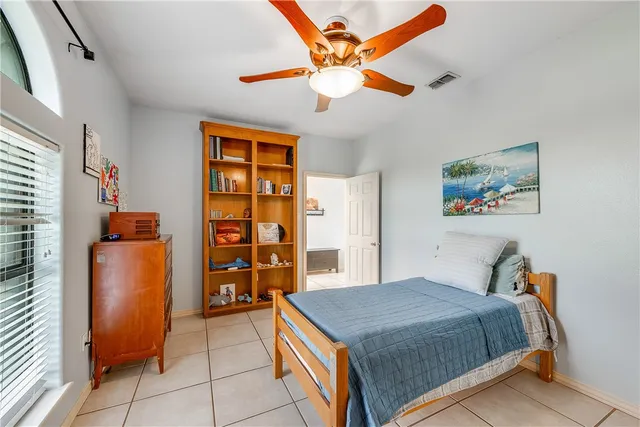 a view of a house with a big yard and large trees