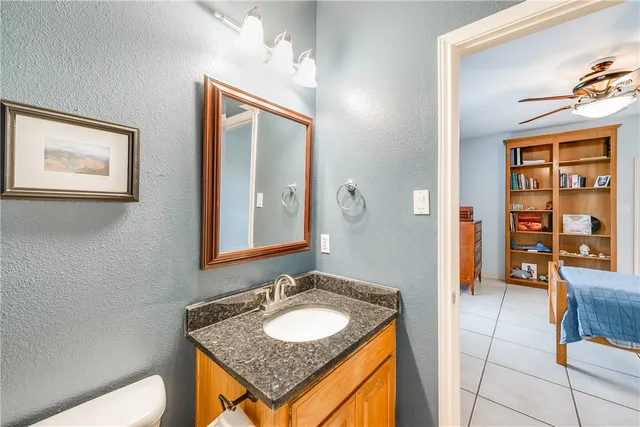 a bathroom with a sink a toilet and mirror