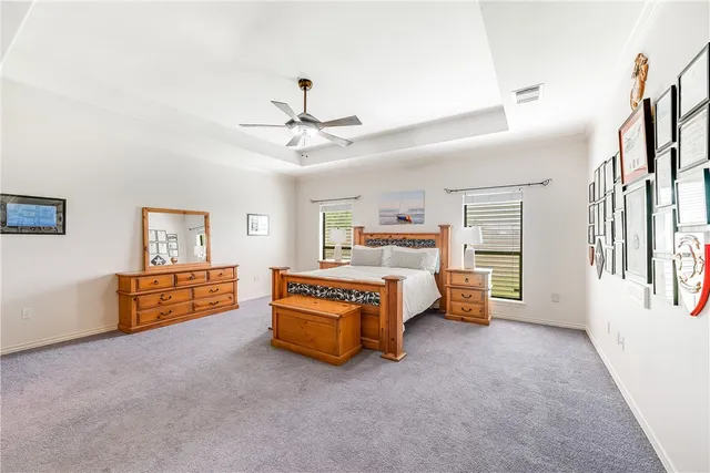 an aerial view of a residential houses with outdoor space and a lake view