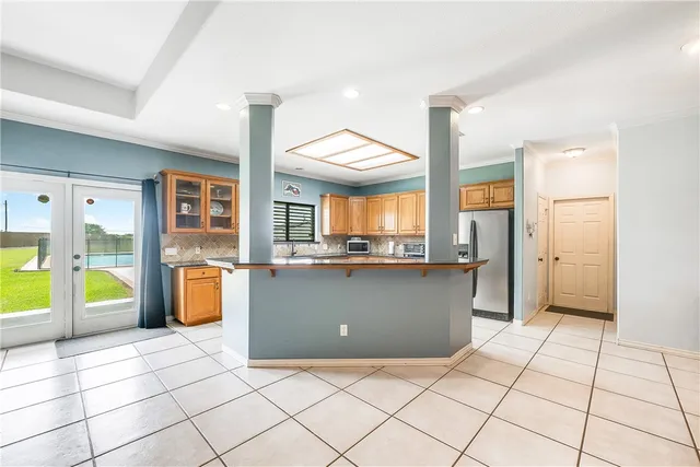 a spacious bedroom with a bed and a chandelier