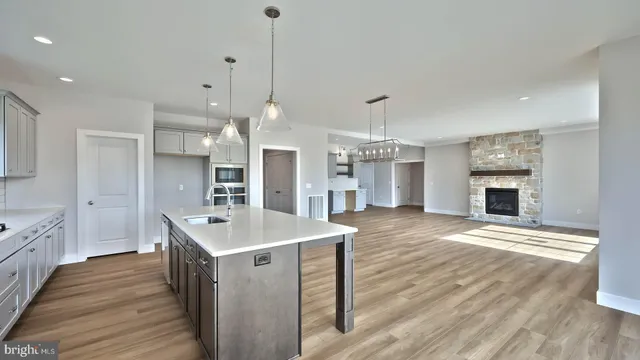 a large kitchen with sink a refrigerator and a stove