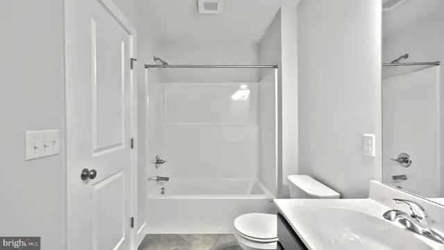 a bathroom with a toilet a sink and a bathtub