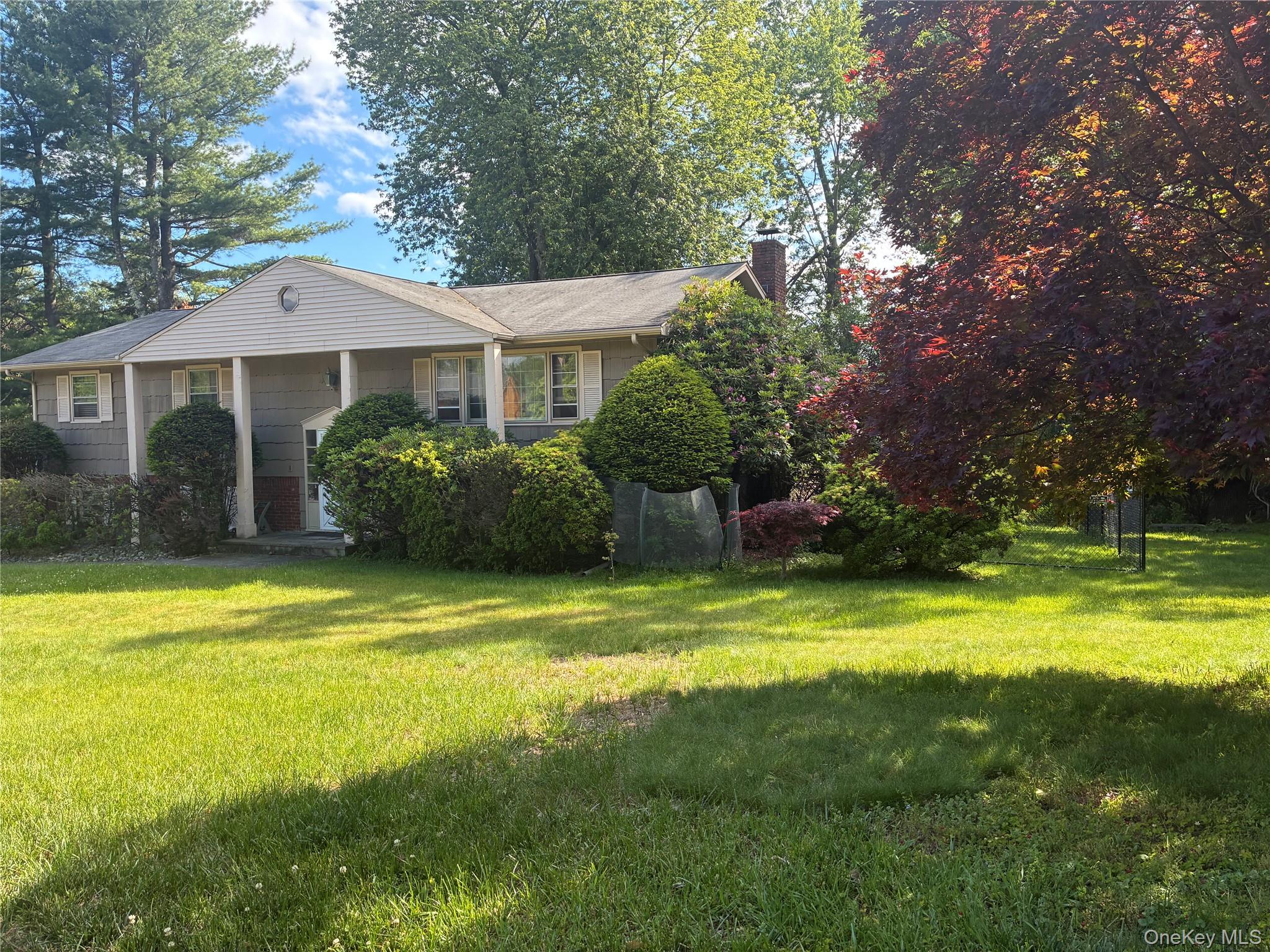 24 Ann Boulevard Spring Valley, NY 10977 - Photo 3 of 25 a front view of a house with swimming pool having outdoor seating