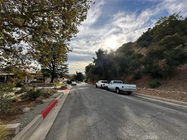 a view of street with parked cars