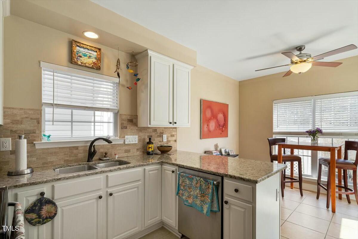 1104 Garnet Ridge Way Raleigh, NC 27607 - Photo 12 of 20 a kitchen with a sink cabinets and window