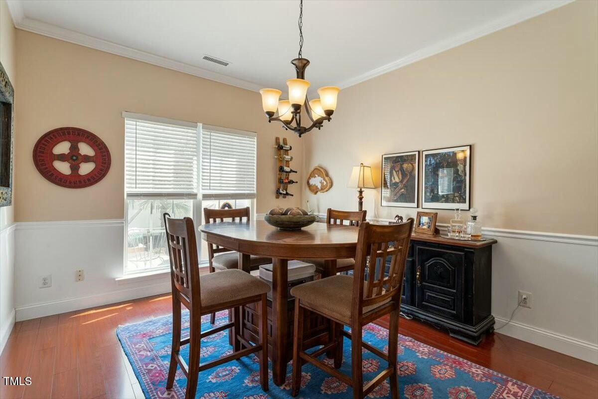 1104 Garnet Ridge Way Raleigh, NC 27607 - Photo 9 of 20 a view of a dining room with furniture a chandelier and wooden floor