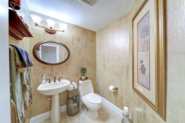 a bathroom with a toilet a sink and a mirror