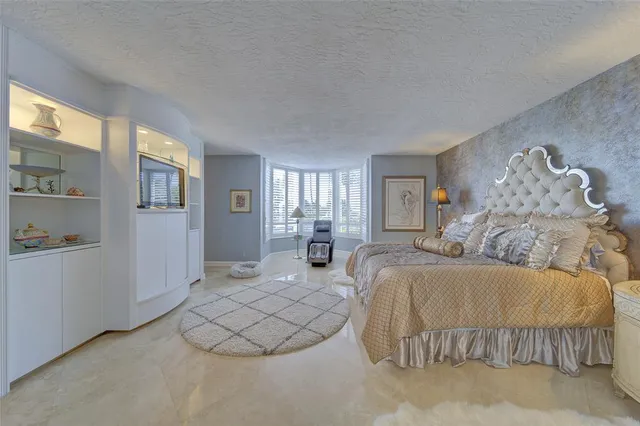 a spacious bedroom with a bed and window