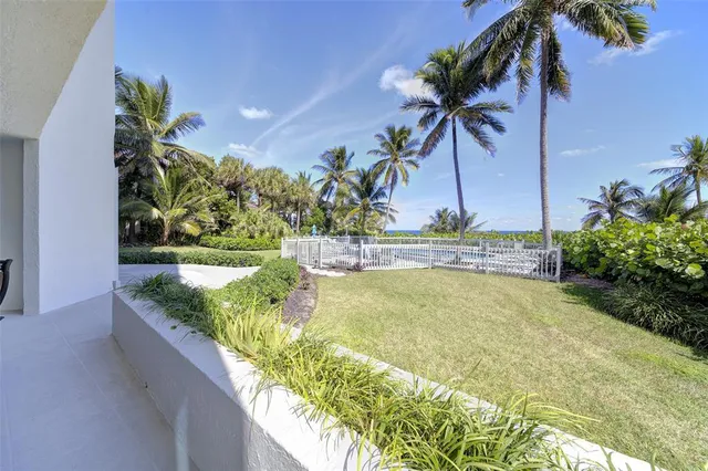 a view of a swimming pool with a table and chairs