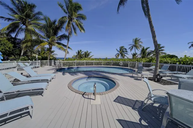 a swimming pool with outdoor seating and yard