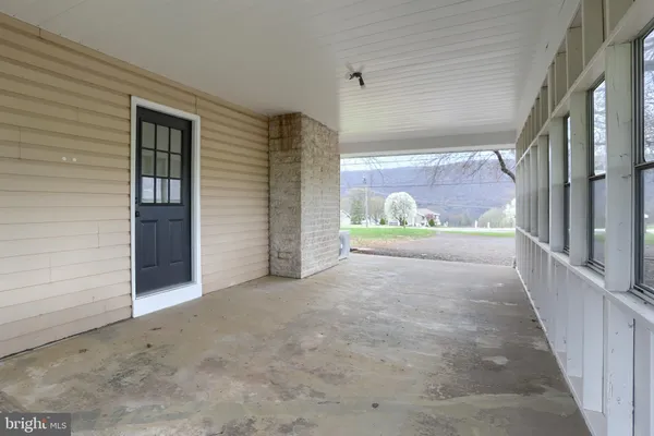 a view of an empty room and bathroom