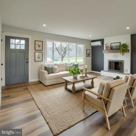 a living room with fireplace furniture and a large window