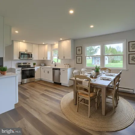 a large kitchen with a table and chairs