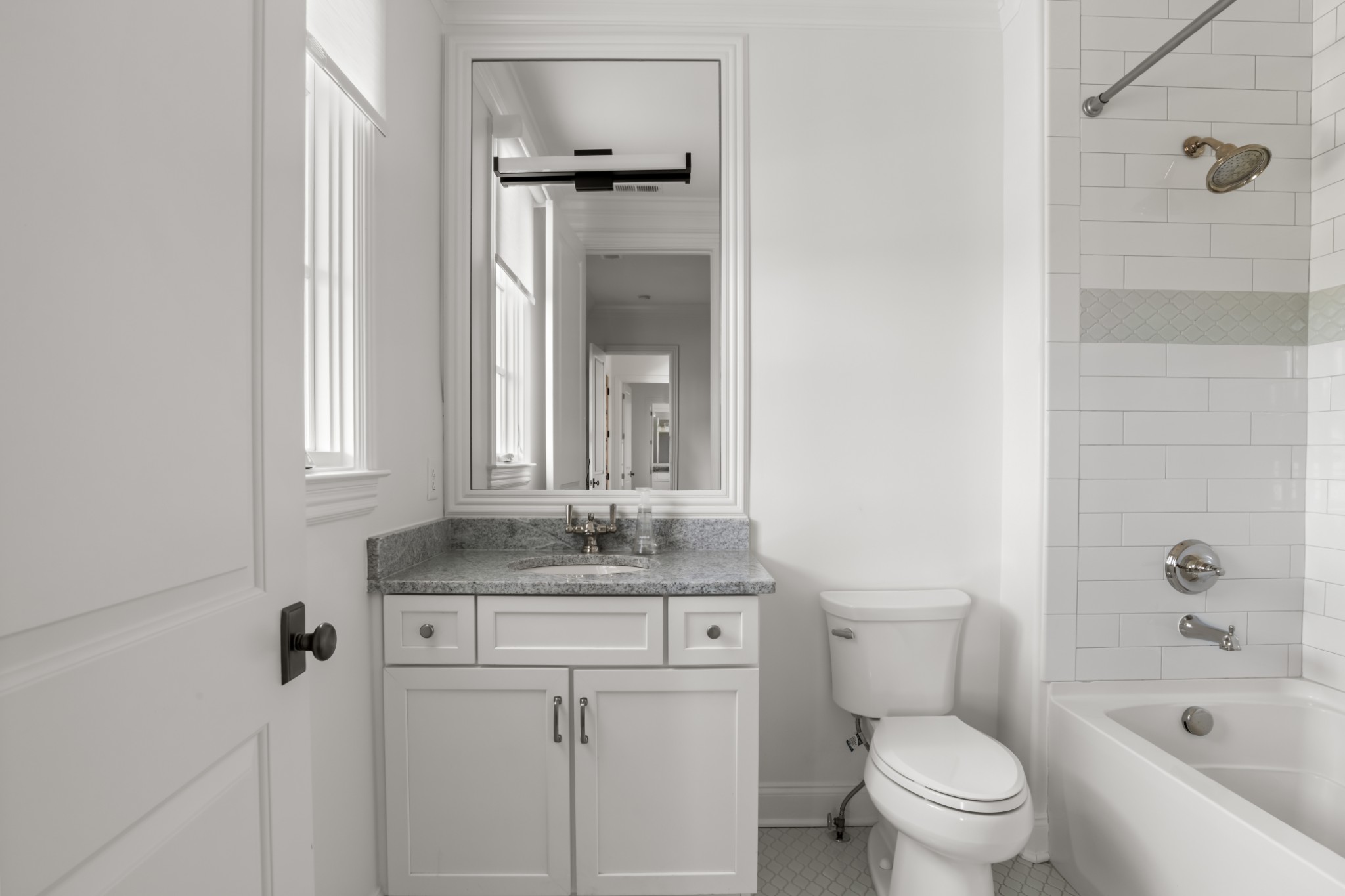 5053 Native Pony Trail College Grove, TN 37046 - Photo 49 of 66 a bathroom with a granite countertop toilet a sink and a bathtub