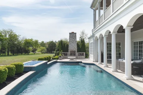 a view of a swimming pool with a lake view