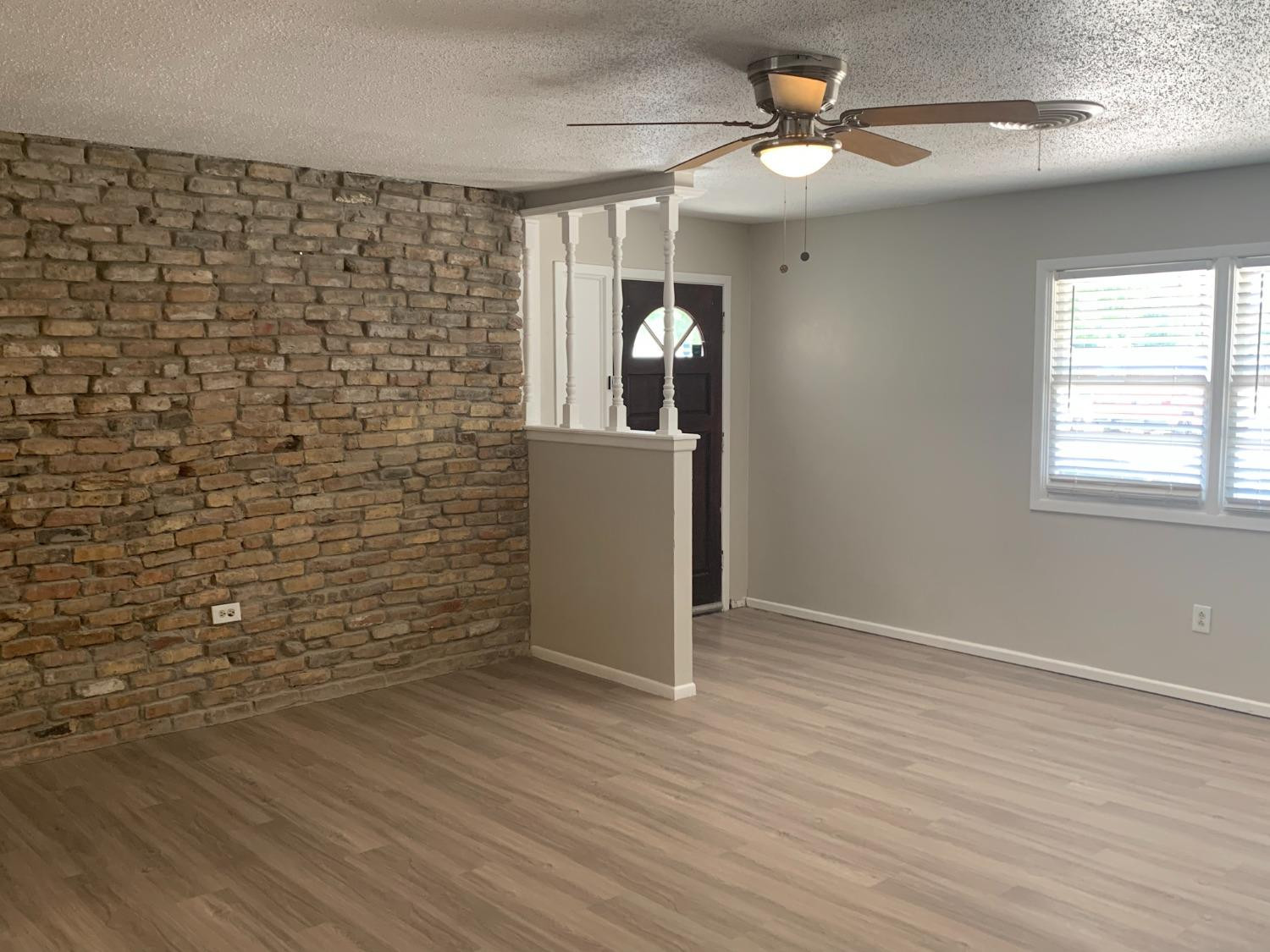 4316 58th Street, Unit A Lubbock, TX 79413 - Photo 3 of 10 a view of a livingroom with wooden floor and a ceiling fan