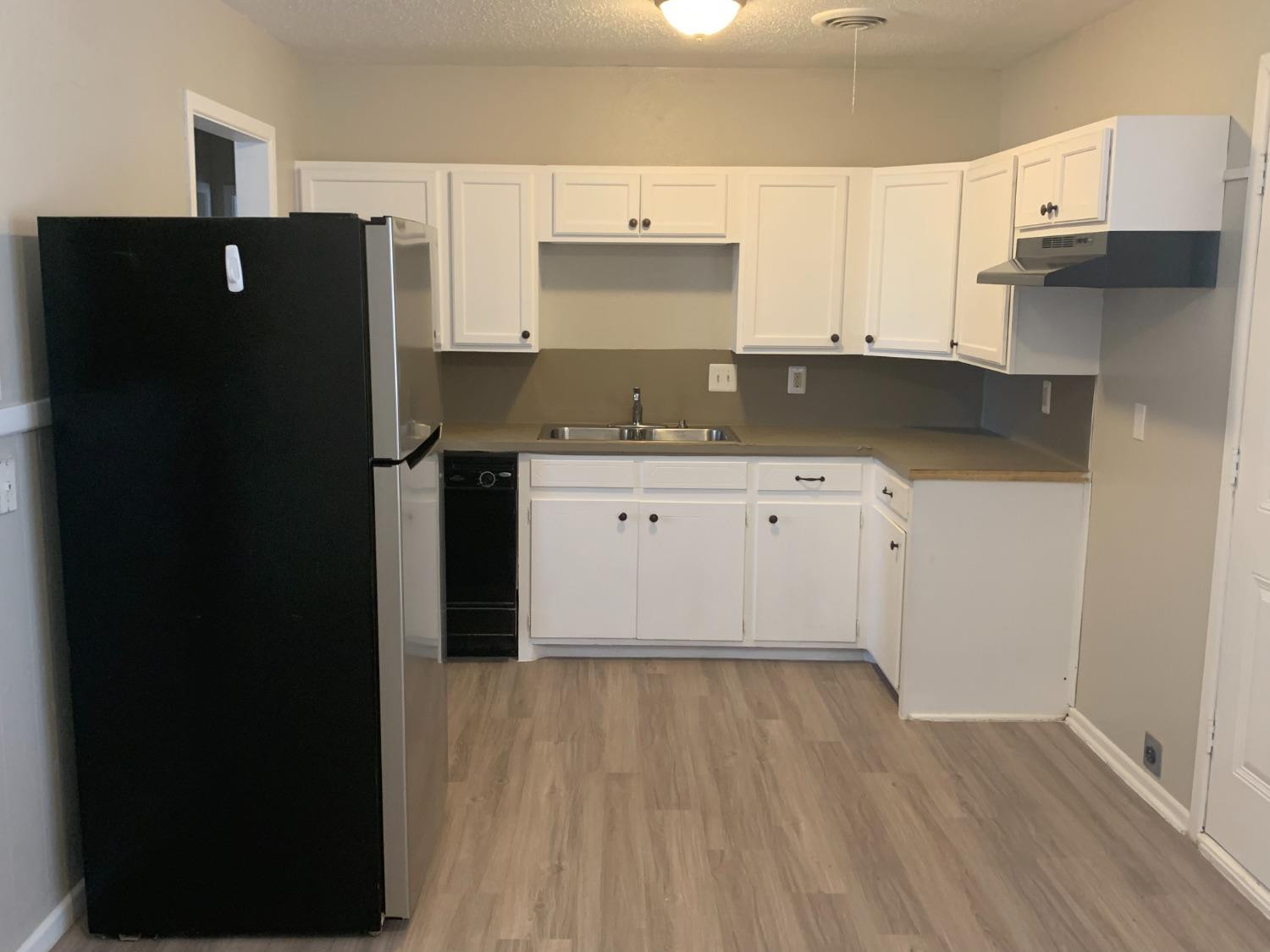 4316 58th Street, Unit A Lubbock, TX 79413 - Photo 4 of 10 a kitchen with a sink and refrigerator