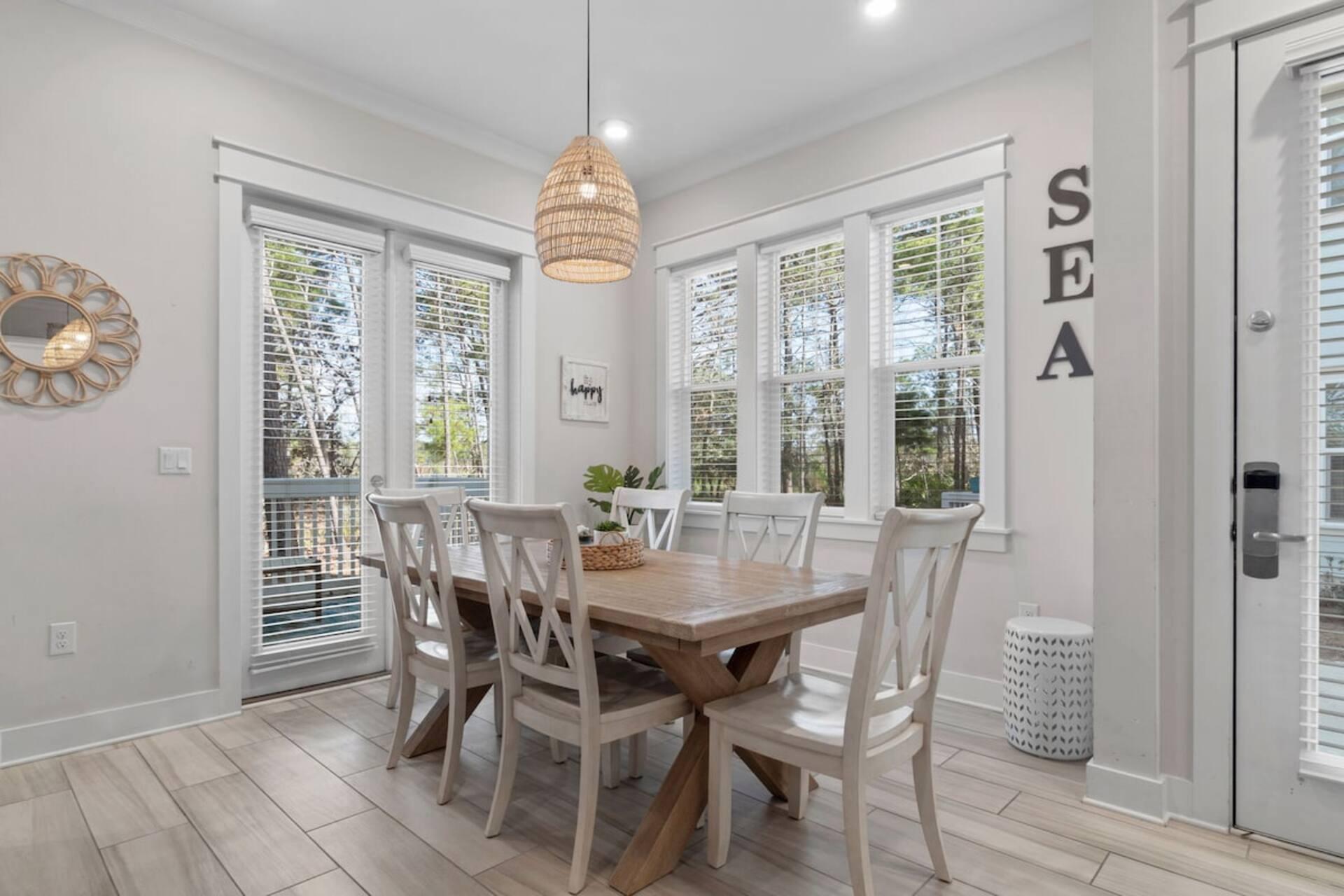 146 East E Pine, Unit B Inlet Beach, FL 32461 - Photo 9 of 47 a view of a dining room with furniture large windows and wooden floor