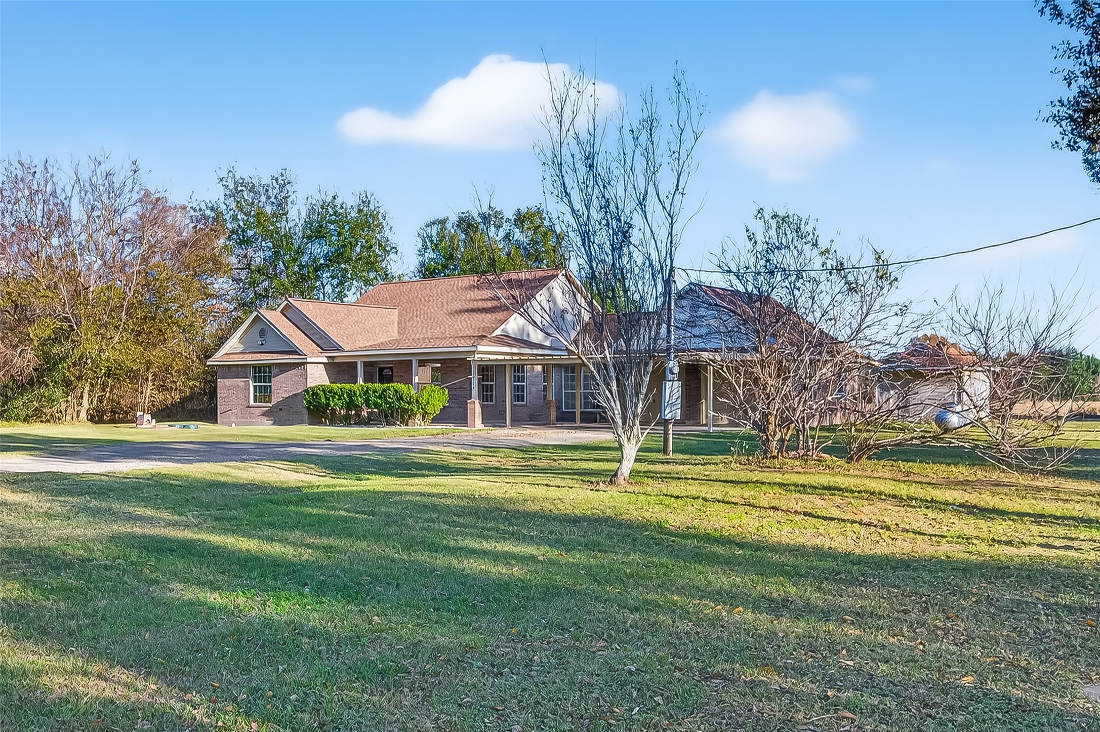 12415 Roesler Road Needville, TX 77461 - Photo 1 of 46 a front view of a house with a yard table and chairs
