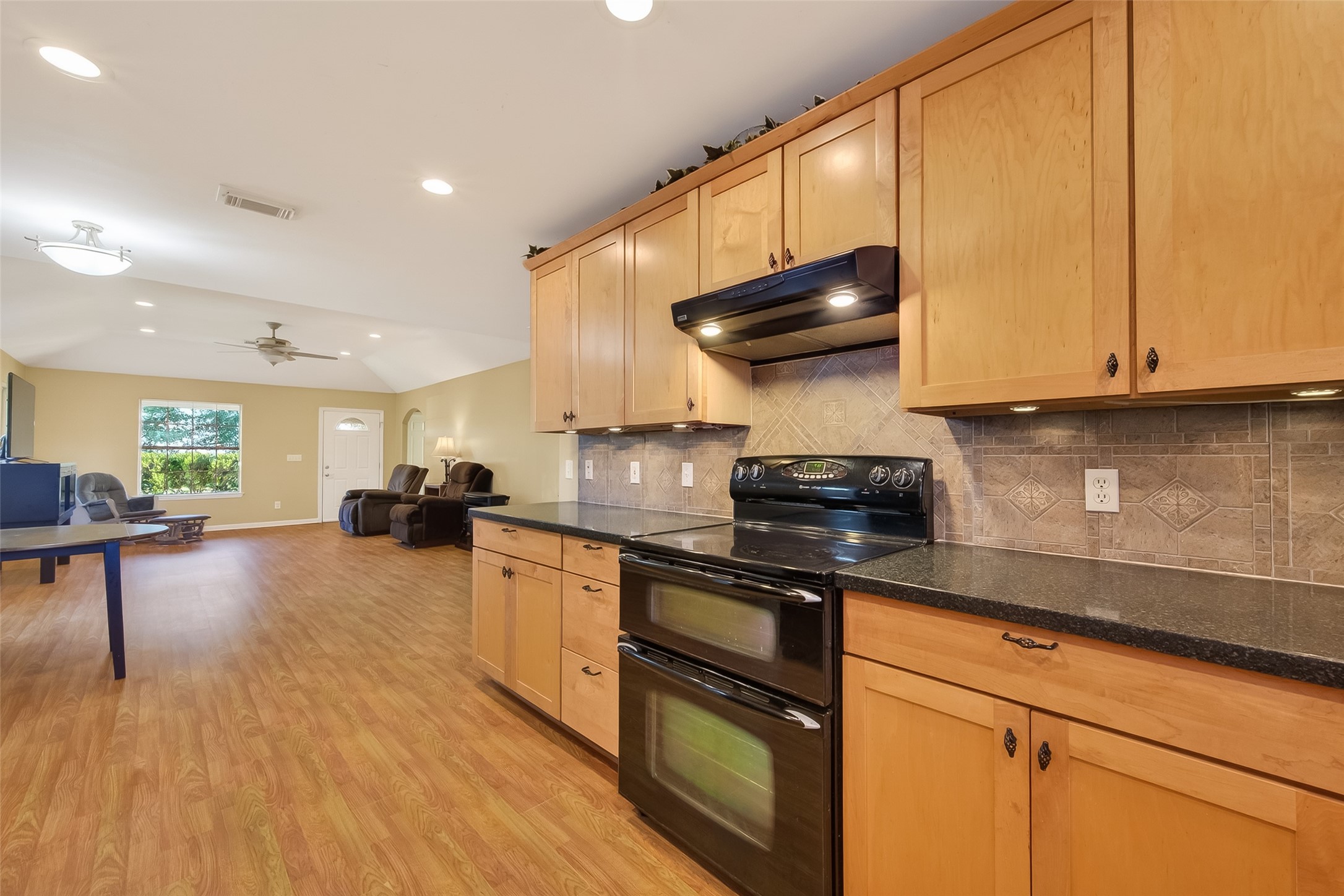 12415 Roesler Road Needville, TX 77461 - Photo 14 of 46 a kitchen with sink cabinets and stove top oven