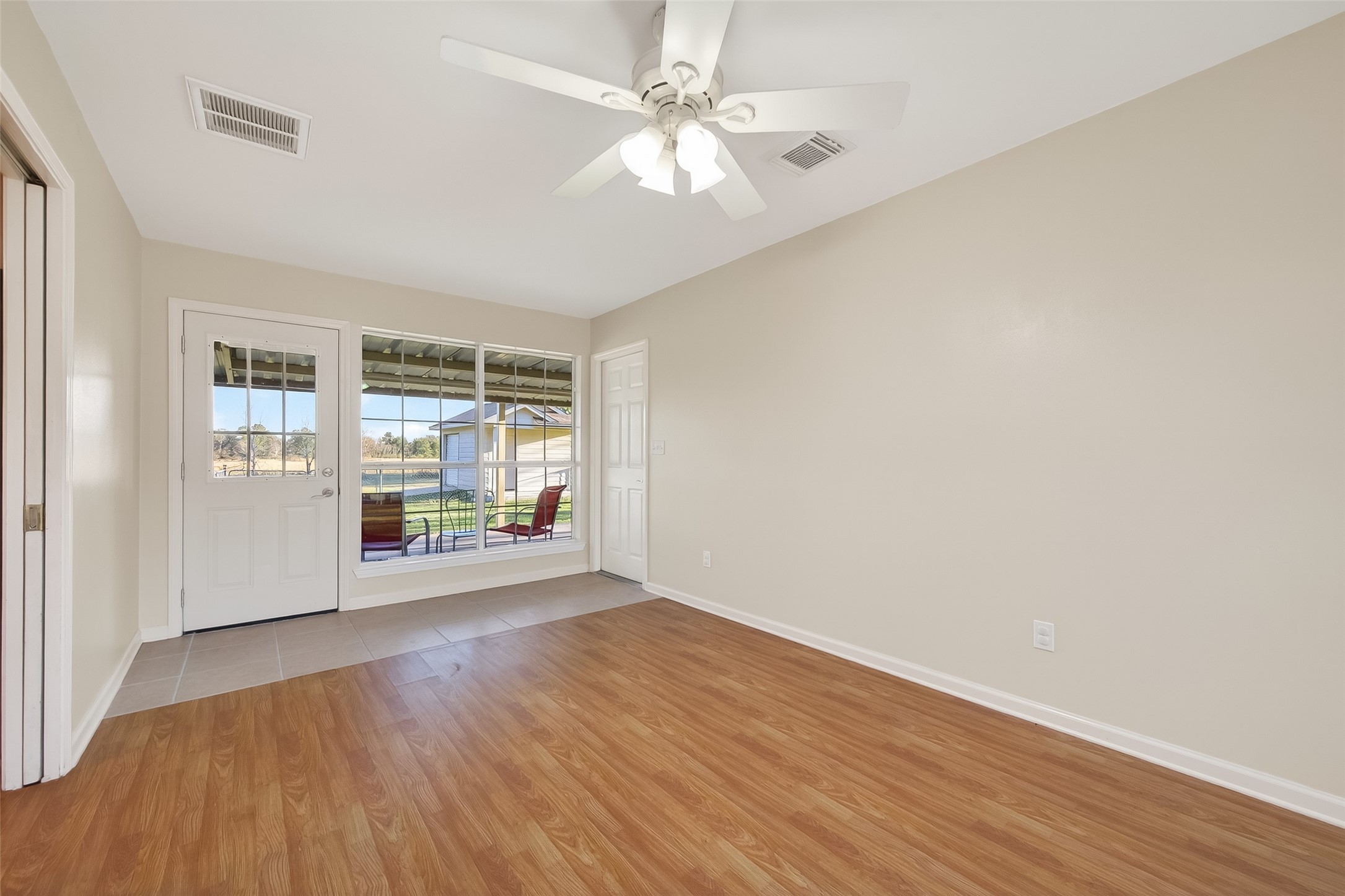 12415 Roesler Road Needville, TX 77461 - Photo 15 of 46 an empty room with wooden floor and windows