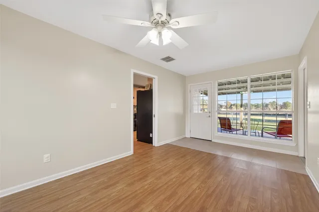 wooden floor in an empty room with a window