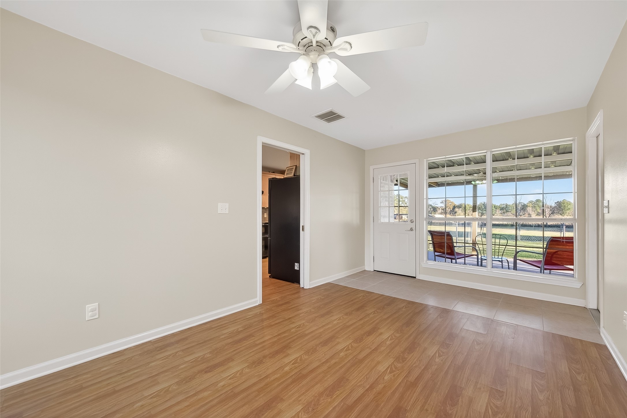 12415 Roesler Road Needville, TX 77461 - Photo 16 of 46 a view of an empty room with a window and wooden floor