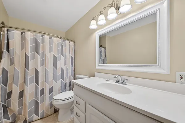 a spacious bedroom with a bed and a window