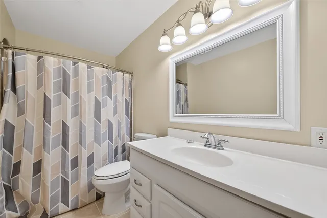 a spacious bedroom with a bed and a window