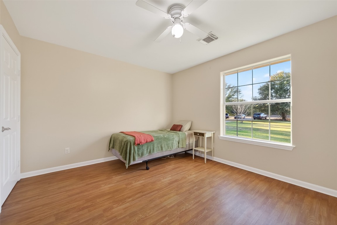 12415 Roesler Road Needville, TX 77461 - Photo 20 of 49 a spacious bedroom with a bed and a window