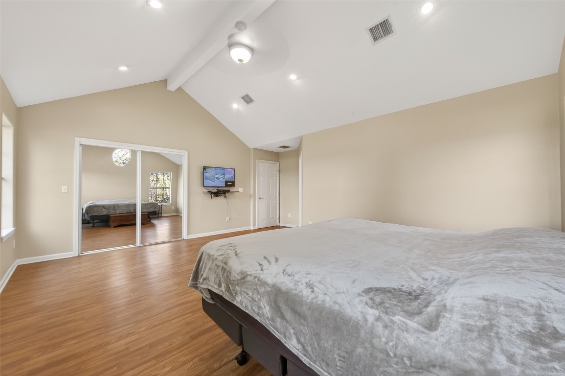 12415 Roesler Road Needville, TX 77461 - Photo 26 of 49 a spacious bedroom with a large bed and a wooden floor