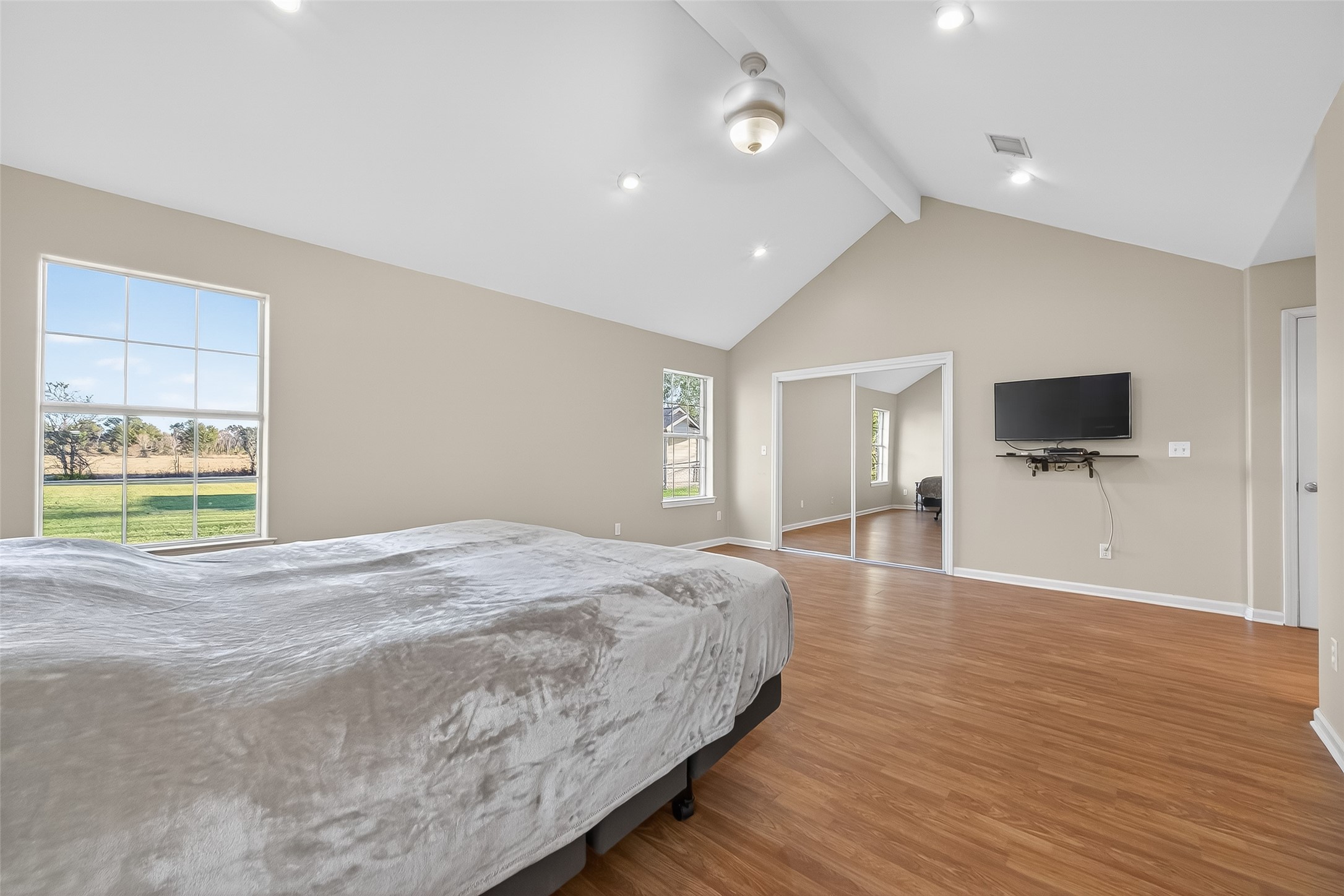 12415 Roesler Road Needville, TX 77461 - Photo 27 of 46 a spacious bedroom with a bed and a flat screen tv