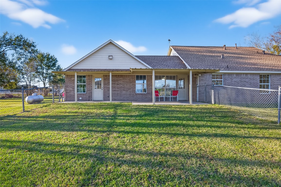 12415 Roesler Road Needville, TX 77461 - Photo 37 of 49 a front view of house with outdoor space and trees in the background