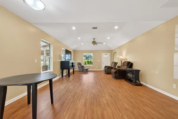 a living room with furniture and a wooden floor