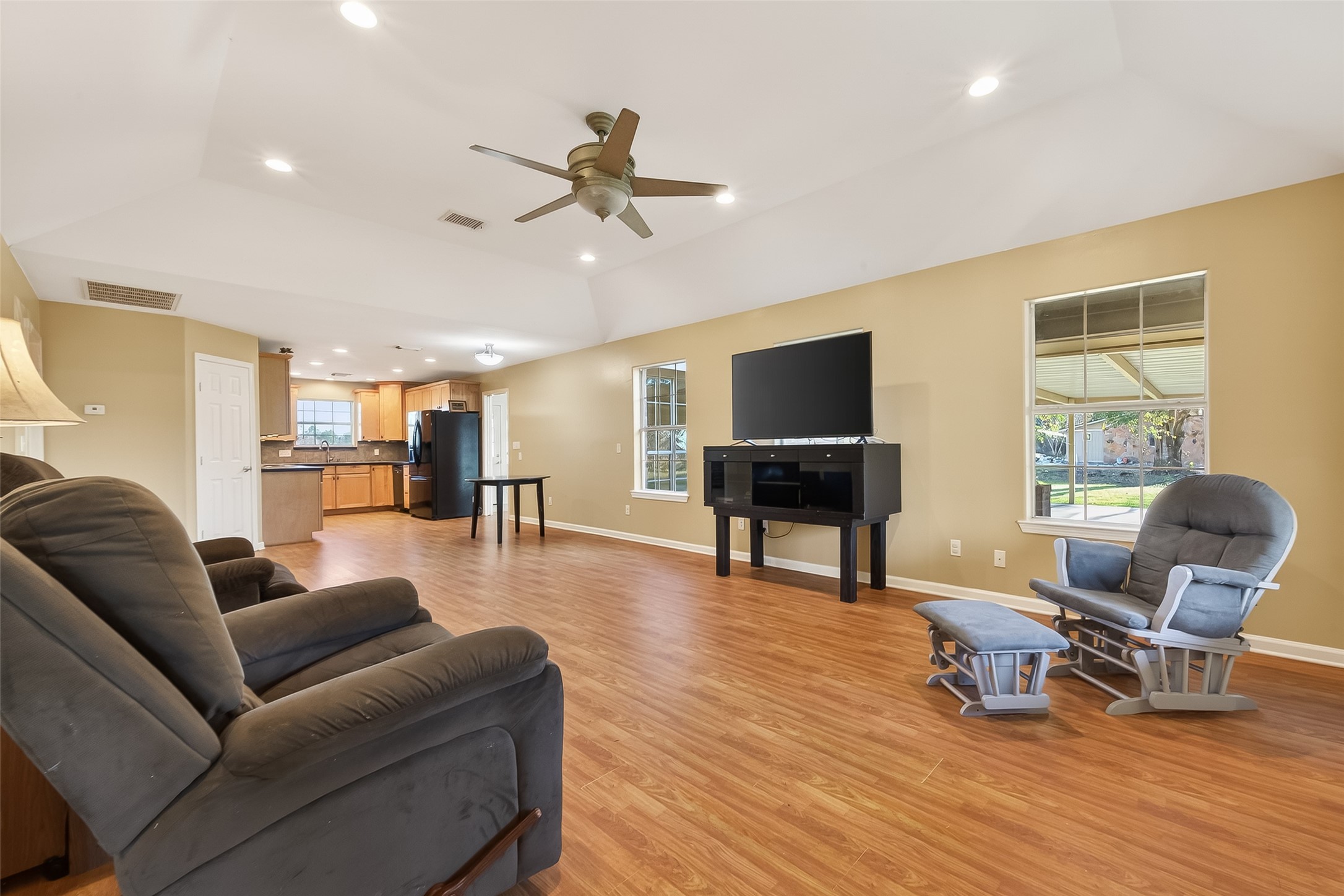 12415 Roesler Road Needville, TX 77461 - Photo 7 of 46 a living room with furniture and a flat screen tv with wooden floor