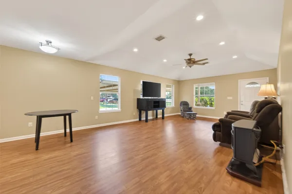 a kitchen with granite countertop stainless steel appliances a refrigerator and cabinets
