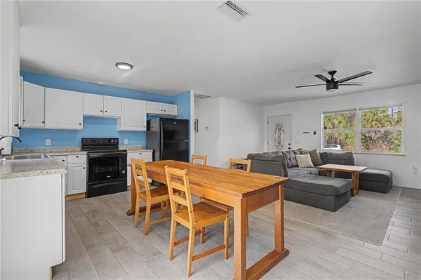 a view of kitchen with cabinets and wooden floor