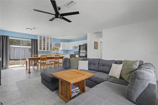 a living room with furniture and kitchen view