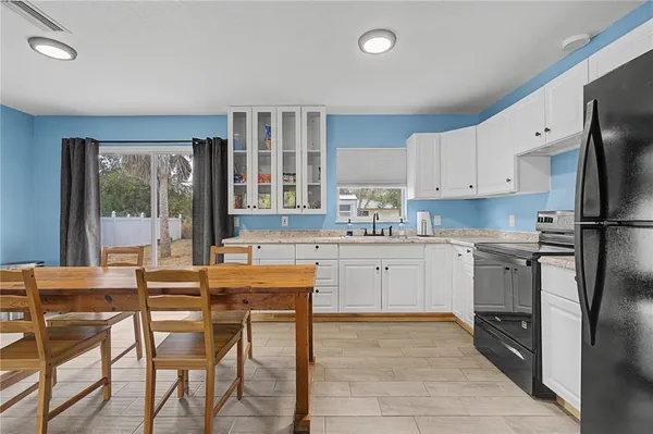a kitchen with white cabinets and white appliances