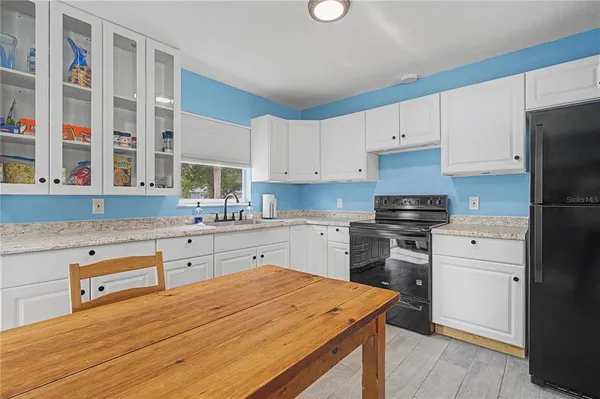 a kitchen with stainless steel appliances cabinets a sink and a stove